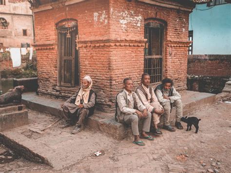 Senior Nepalese male neighbors resting on street of poor village · Free Stock Photo