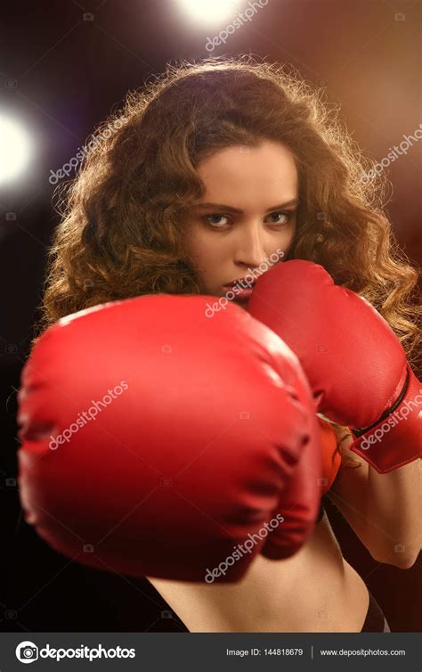 Young woman in boxing gloves Stock Photo by ©SergIllin 144818679