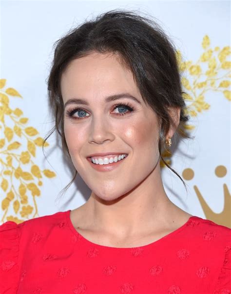 Close-up of a person in a red dress with a joyful smile