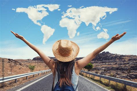 Happy travel woman on vacation concept with world shaped clouds. Funny traveler enjoy her trip ...