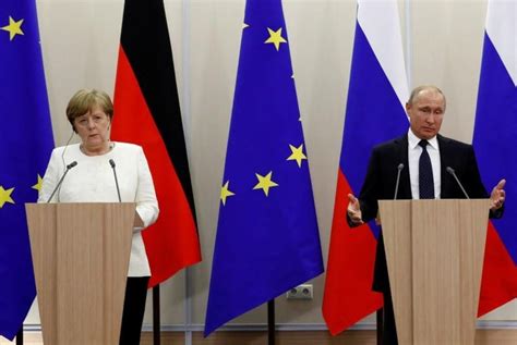 Merkel, Putin tackle tough topics in meeting outside Berlin – Firstpost