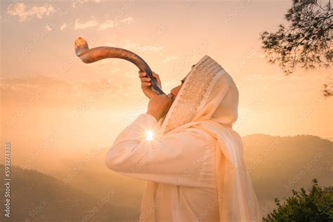 A Jewish man blowing the Shofar (ram's horn), which is used to blow ...