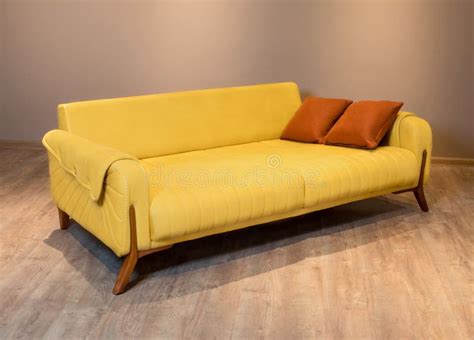 Closeup Shot of a Yellow Modern Couch on a Wooden Floor Stock Photo ...