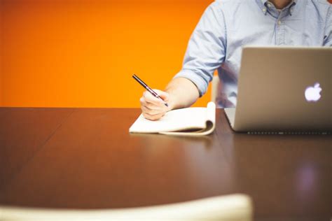 White Printer Paper Beside Macbook Pro on Black Surface · Free Stock Photo