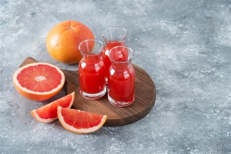 Free Photo | Glass pitchers of fresh grapefruit juice with slices of ...