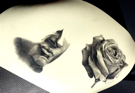 a drawing of two roses sitting on top of a white plate next to each other