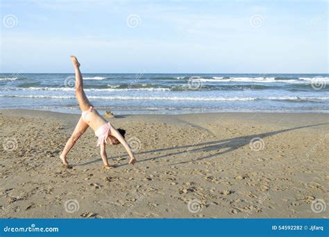 Girl Doing Cartwheel on the Beach Stock Photo - Image of beach, oliva: 54592282