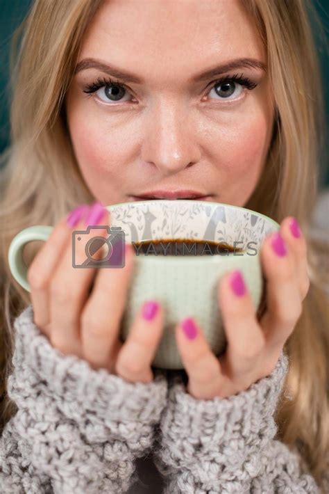 YAY Images - An attractive blonde woman covers her face with a large cup of coffee. by ...