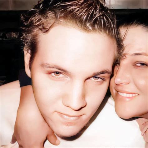 a man and woman are posing for a photo with their heads close to each other