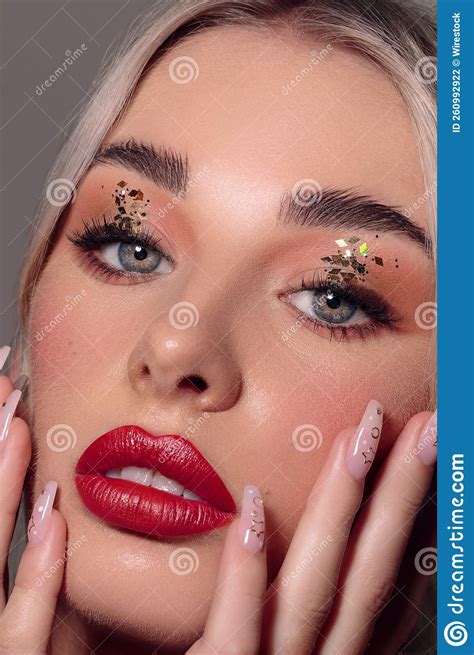 Vertical Closeup of a Portrait of an Attractive Woman with Red Lipstick and Glitter on Her Eyes ...