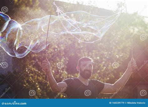 Man making soap bubbles stock image. Image of making - 160239779