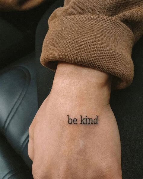 Tattoo that says "be kind" done on the hand.