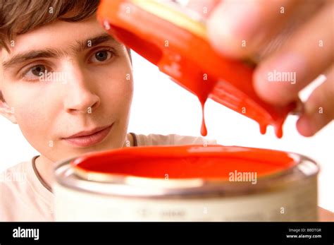 Young man opening paint can Stock Photo - Alamy