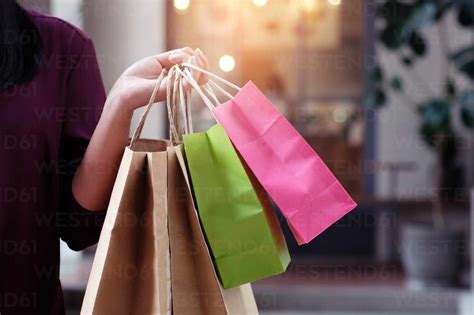 Cropped Image Of Woman Holding Shopping Bags In City stock photo