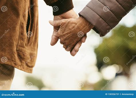 Elderly Couple Holding Hands Walking