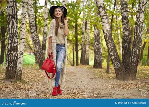 Young Woman in Fashion Blue Jeans and Red Bag Walking in Autumn Stock Photo - Image of blue ...