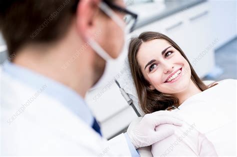 Dentist and patient smiling - Stock Image - F015/7505 - Science Photo Library