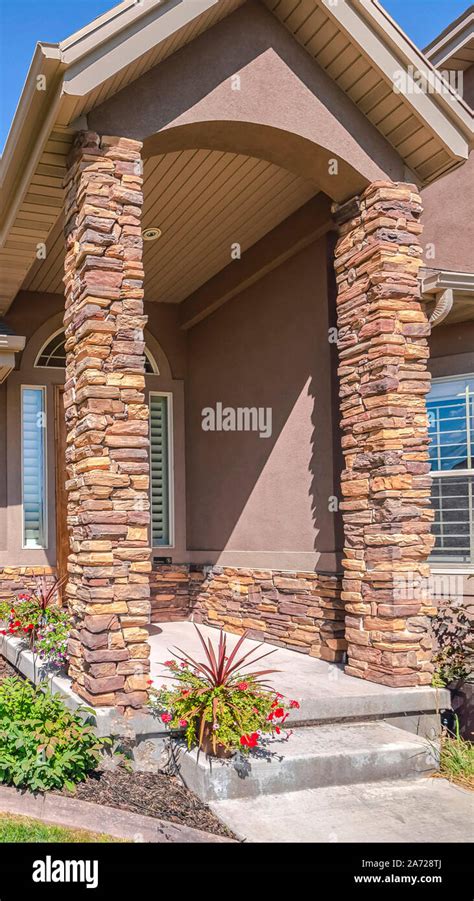 Vertical Modern house and front yard with stone pillars Stock Photo - Alamy