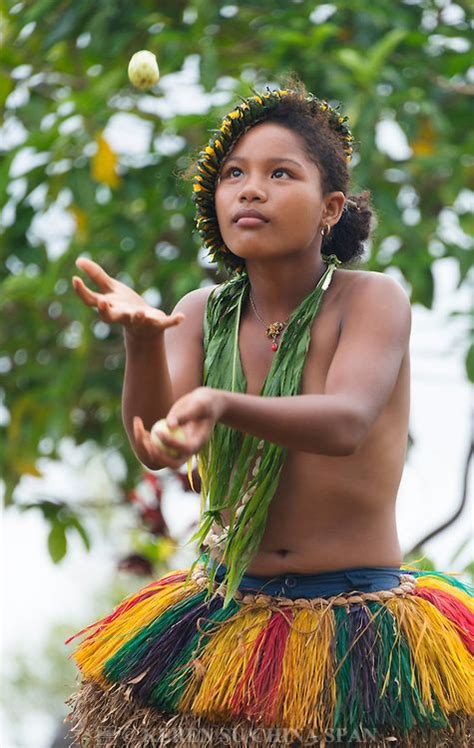 Yapese girl in traditional clothing juggling fruit at Yap Day Festival, Yap Island, Federated ...