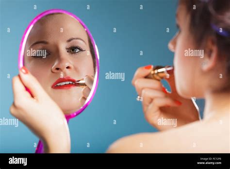 Woman applying red lipstick Stock Photo - Alamy