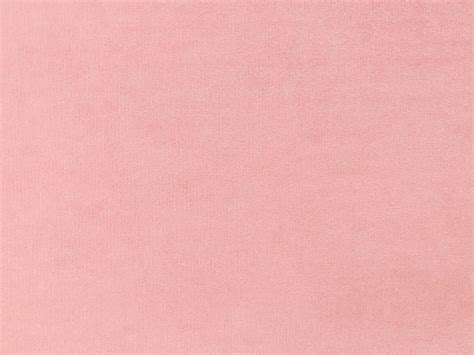 light orange-pink velvet fabric texture used as background. Empty light orange fabric background ...