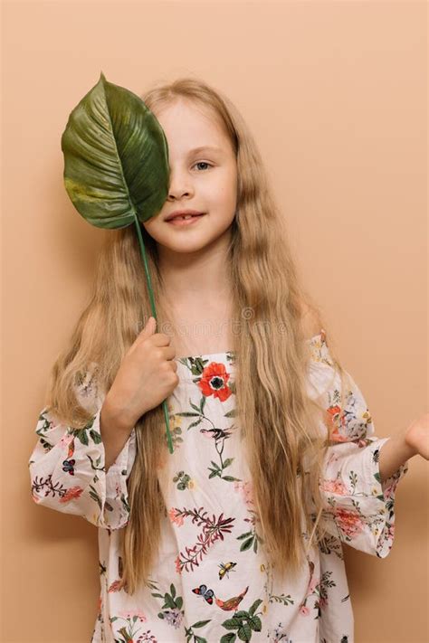 Little Girl on a Beige Background with a Green Leaf Stock Image - Image of nature, headshot ...