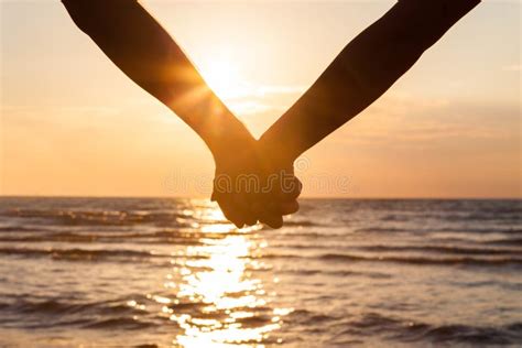Couple, Pov and Holding Hands on Beach for Love with People Outdoor at Sunset Together. Nature ...