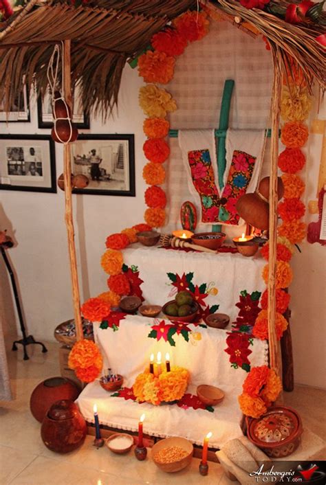 a decorated altar with candles and flowers on the table for people to ...