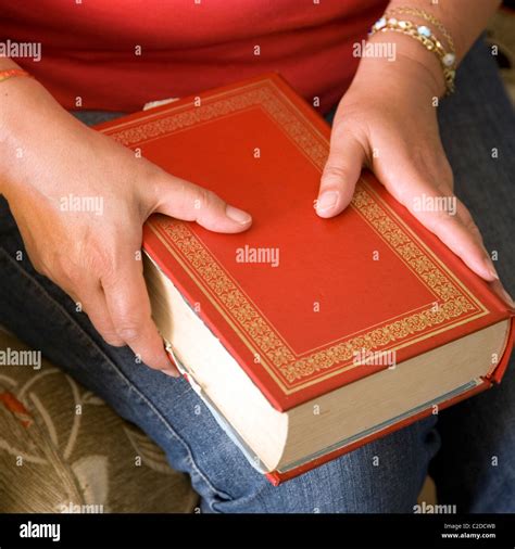 Woman holding big red book Stock Photo - Alamy