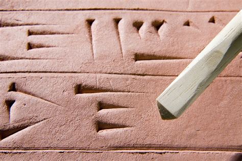 Cuneiform clay tablet and stylus - Stock Image - C001/8605 - Science Photo Library