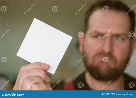 A Blank White Square-shaped Sheet of Paper in the Hand in the Background Stock Image - Image of ...