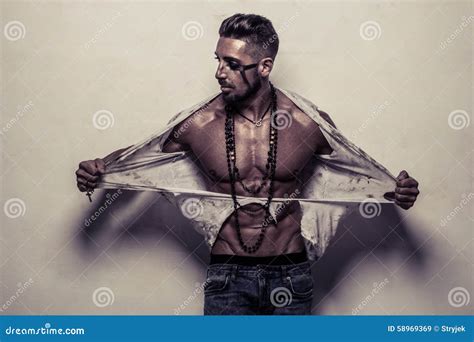 Muscular Man In Ragged Clothes Ripping Off His Shirt Stock Photo ...