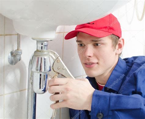 Plumber in uniform repairing old pipeline in the house. — Stock Photo ...