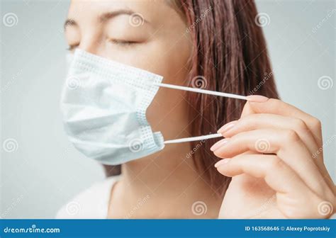 Woman Puts on a Medical Mask Against Air Infection Diseases. Stock Photo - Image of protection ...