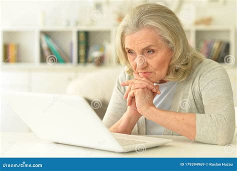 Senior Woman Sitting at Table with Laptop Stock Image - Image of program, people: 179394969