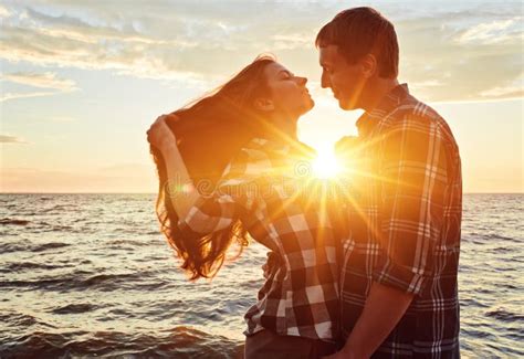 A Couple Holding Hands during an Sunset Stock Image - Image of beach, lake: 214025487