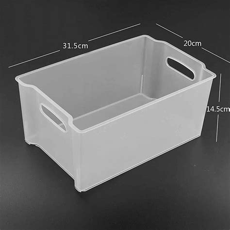 a white plastic storage container with measurements for the bottom and side handles on it ...