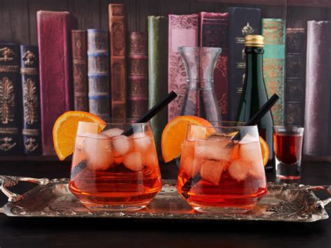Two Glasses Of Spritz Set On A Silver Tray With A Bookshelf Wallpaper Background Stock Photo ...