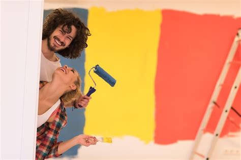 Premium Photo | Portrait of happy smiling young couple painting ...