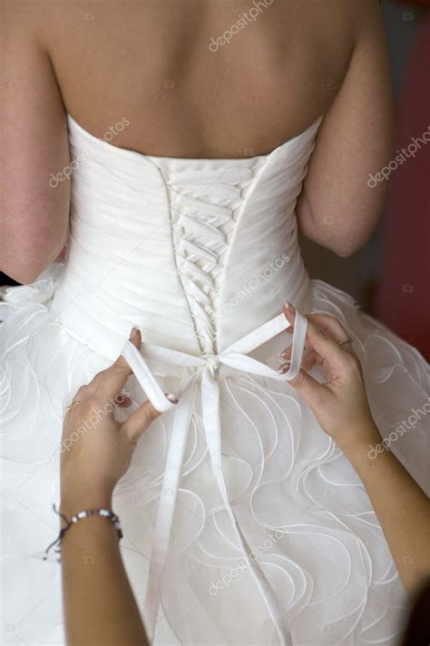 Tying the bow on a wedding dress — Stock Photo © eelnosiva #11705209