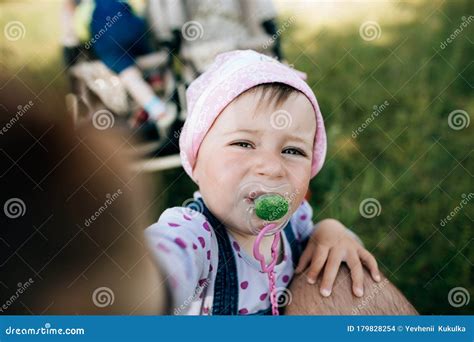 Funny Little Girl with a Pacifier in Her Mouth Stock Photo - Image of kids, sunset: 179828254