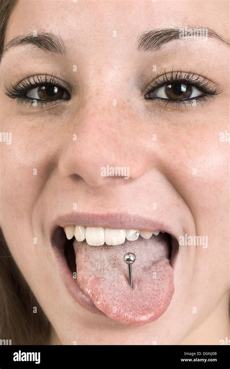 Woman with tongue piercing Stock Photo - Alamy