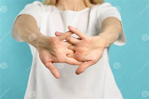 Woman Cracking Her Knuckles on Turquoise Background, Closeup. Bad Habit Stock Photo - Image of ...