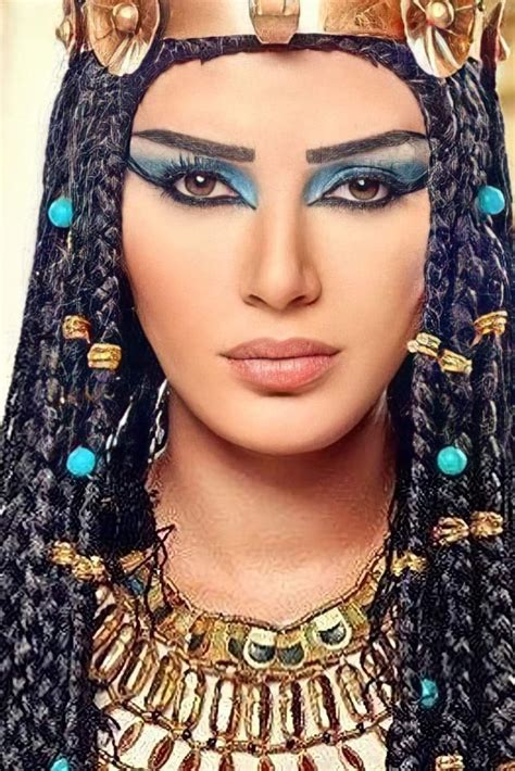 an egyptian woman with blue eyes and gold jewelry on her head, wearing a costume