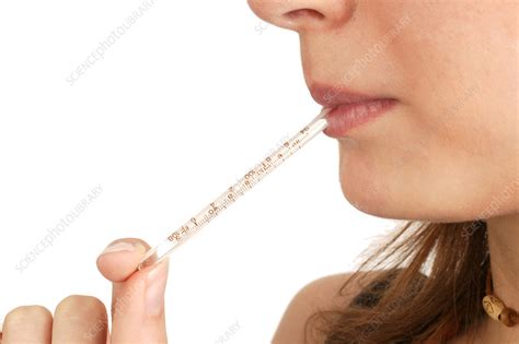 Woman with a thermometer in her mouth - Stock Image - C053/1087 - Science Photo Library