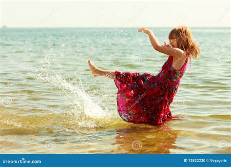 Little Girl Kid Splashing in Sea Ocean Water. Fun Stock Photo - Image of travel, dress: 75822230