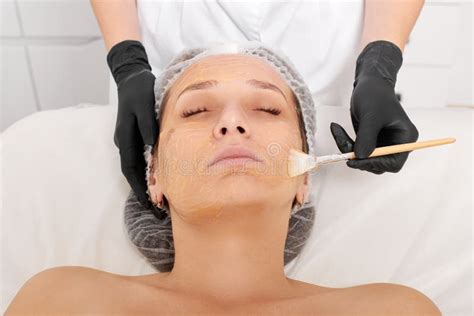 Cosmetologist Applies Honey Mask on Woman Face for Moisturize Face Skin in Beauty Spa Salon ...