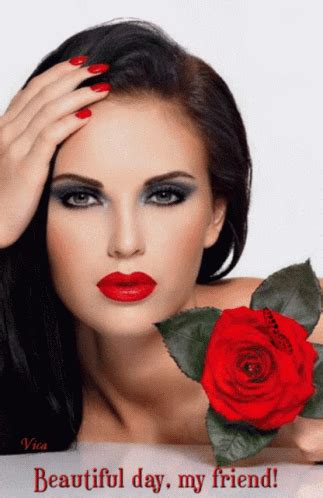 a woman with long black hair and red lipstick holds a rose in front of ...