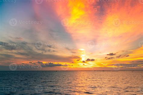 Beautiful sunset sky. Beach sunset. Twilight sea and sky. Tropical sea at dusk. Dramatic orange ...