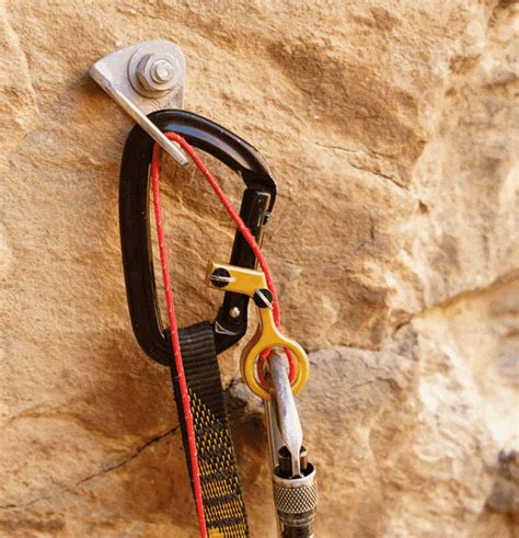 a rock climber's gear hanging on the side of a wall